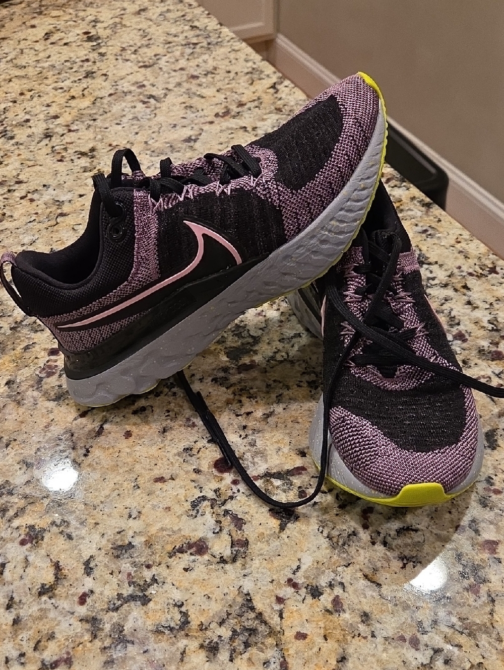 Nike Women's React Infinity Run Flyknit 2 running shoes in a black and violet.